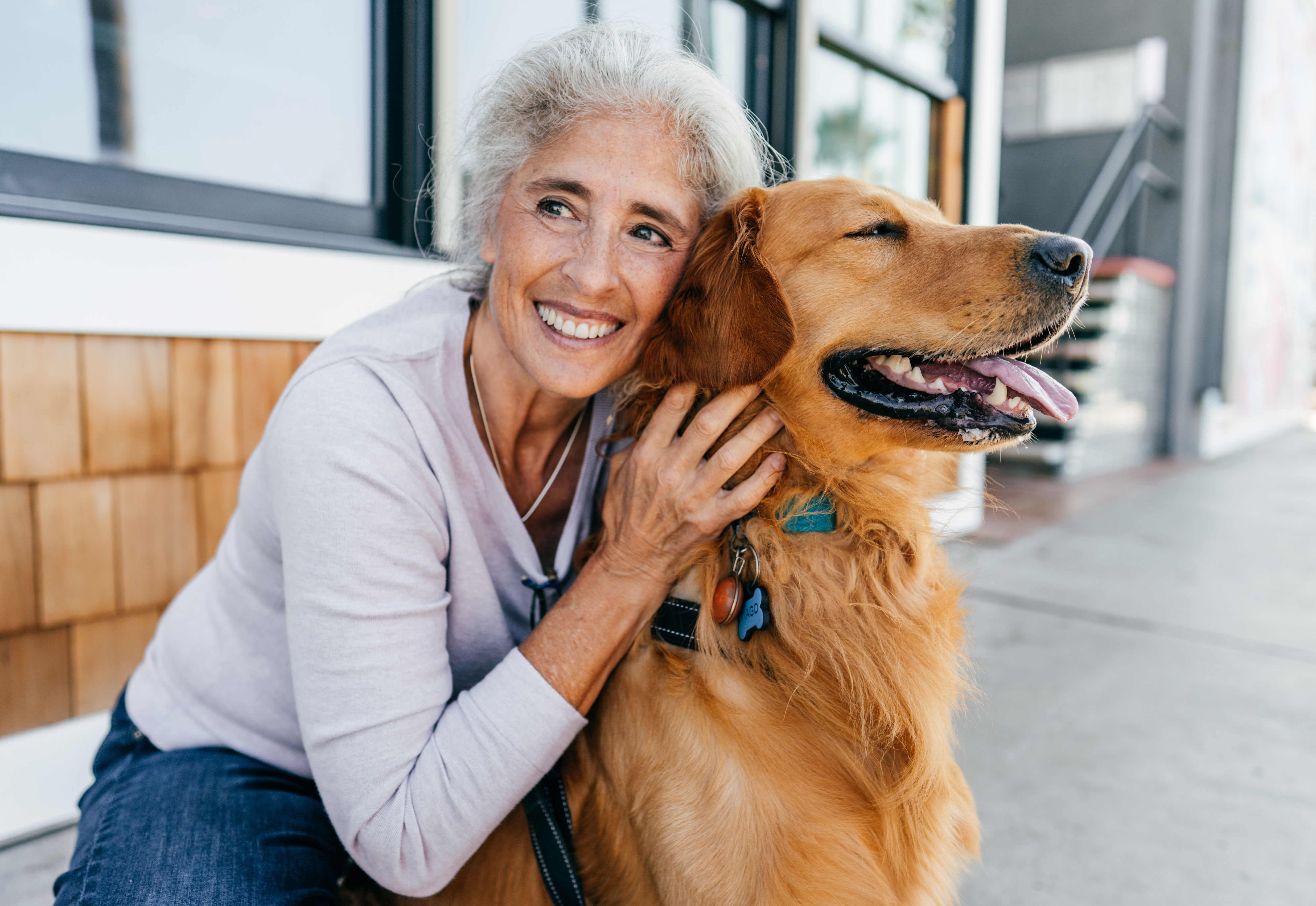 Woman hugging happy dog